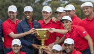 US team captain Tiger Woods (top row, 2nd L) and his teammates pose with the Presidents Cup after their win over the International Team on the final day of the Presidents Cup golf tournament in Melbourne on December 15, 2019. AFP / Simon Baker