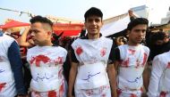 Protesters stage a protest with symbolic blooded clothes to draw attention to the human rights violations suffered by Iraqi people as they continue their anti-government demonstrations in Baghdad, Iraq on December 15, 2019. (Murtadha Sudani/Anadolu Agency