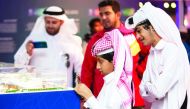 Visitors look at the FIFA World Cup Qatar 2022 stadium’s model at Darb Al Saai. 