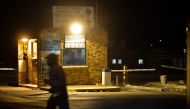 A pedestrian walks by the community centre at the Chris Hani Baragwanath Hospital in the South African landmark township of Soweto on April 24, 2014. AFP / Mujahid Safodien
