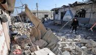 Syrians check the site of a reported government bombardment in the village of Maasaran on the outskirts of Maaret al-Numan in northwestern Idlib province on December 17, 2019. AFP / Omar Haj Kadour 