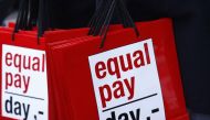People carry bags reading 'equal pay day' during a protest a day before International Women's Day, in Bern March 7, 2015. Reuters/Ruben Sprich