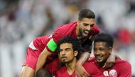 Qatar players celebrate after scoring during a 24th Arabian Gulf Cup match. (AFP / KARIM JAAFAR/File Photo)