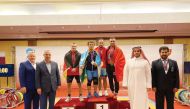 The podium winners of the men’s 73 weight class posing for a photograph with the officials.