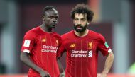Liverpool's Sadio Mane (L) speaks with Liverpool's Salah during the 2019 FIFA Club World capital. Doha. December 18, 2019. / AFP / KARIM JAAFAR