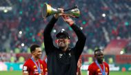 Liverpool’s manager Jurgen Klopp celebrates with the trophy. 