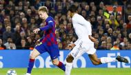 Barcelona's Dutch midfielder Frekie De Jong (L) vies with Real Madrid's French defender Raphael Varane (R) during Spanish El Clasico football match between FC Barcelona and Real Madrid at the Camp Nou stadium in Barcelona on December 18, 2019. Adria Puig 
