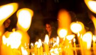 Representative image: Worshippers light candles as they attend Christmas Mass at the Saint Antuan Church in the Beyoglu district of Istanbul, on December 24, 2019.  AFP / Yasin Akgul
 