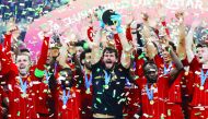 Liverpool's Alisson lifts the trophy as they celebrate after winning the Club World Cup in Doha. 
