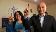 Barham Salih with his wife show their ink-stained fingers at a polling station in Sulaimaniyah, Iraq, May 12, 2018. Reuters / Ari Jalal