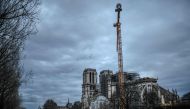 A picture taken on December 26, 2019 shows a giant crane outside the Notre-Dame Cathedral in Paris, which was partially destroyed when fire broke out beneath the roof on April 15, 2019.  AFP / Stephane De Sakutin