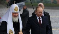 File photo: Russian President Vladimir Putin with Russian Orthodox Patriarch Kirill to place flowers at a statue of Minin and Pozharsky, the leaders of a struggle against foreign invaders in 1612 on Nov 4, 2013. AFP