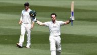 Australian batsman Travis Head celebrates scoring his century as New Zealand captain Kane Williamson (L) looks on during the second day of the second cricket Test match at the MCG in Melbourne on December 27, 2019. AFP / William West