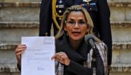 Bolivian interim President Jeanine Anez shows a document as she presents a bill on the Transition Electoral Regime for the 2020 general elections in La Paz on November 20, 2019. AFP / Jorge Bernal