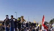 Protesters gather to condemn air strikes on bases belonging to Hashd al-Shaabi (paramilitary forces), outside the main gate of the US Embassy in Baghdad, Iraq on December 31, 2019. (REUTERS/Thaier al-Sudani)