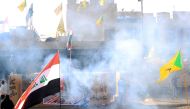 U.S. Embassy security men use stun grenades to disperse protesters and militia fighters during a protest to condemn airstrikes on bases belonging to Hashd al-Shaabi (paramilitary forces), outside the U.S. Embassy in Baghdad, Iraq January 1, 2020. REUTERS/