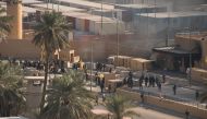 Iraqi security forces and protesters stand outside the U.S. embassy in Baghdad, Iraq January 1, 2020. DoD/Lt. Col. Adrian Weale/Handout via Reuters