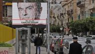 This December 6, 2018 photo shows a portrait of ousted Nissan chairman Carlos Ghosn on a publicity billboard on a street in Beirut. AFP / Joseph Eid
 