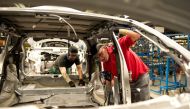 Nissan manufacturing staff works in the Trim and Chassis section of their Sunderland Plant in north east England on November 12, 2014. AFP / Oli Scarff