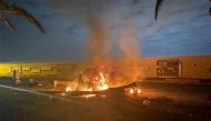 A picture published by the media office of the Iraqi military's joint operations forces on their official Facebook page shows a destroyed vehicle on fire following a US strike on January 3, 2020 on Baghdad international airport road in which top Iranian c