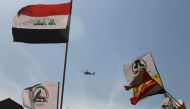 A military helicopter flies over the US embassy as supporters of Hashed al-Shaabi paramilitary protest in the Iraqi capital Baghdad on January 1, 2020. AFP / Ahmad Al-Rubaye