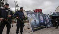 Hamas policemen in Gaza City stand guard during a mourning ceremony organised in honour of slain Iranian military commander Qasem Soleimani (portrait) killed in the Iraqi capital Baghdad in a US air strike a day earlier, on January 4, 2020. / AFP / MAHMUD