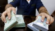 FILE PHOTO: A money exchange vendor displays Lebanese pound banknotes at his shop in Beirut, Lebanon, August 16, 2018. REUTERS/Mohamed Azakir