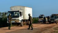 Kenyan police officers check vehicles on a road after a bus, travelling from the coastal region of Lamu to the town of Malindi, was ambushed by gunmen in Lamu county, southeast Kenya, on January 2, 2020.  AFP / STRINGER