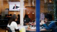 Customers at a Japanese restaurant watch on TV the live news conference of former Nissan chairman Carlos Ghosn in Paris, France January 8, 2020. Reuters/Benoit Tessier
 