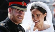 Britain's Prince Harry, Duke of Sussex and his wife Meghan, Duchess of Sussex wave from the Ascot Landau Carriage during their carriage procession on the Long Walk as they head back towards Windsor Castle in Windsor, after their wedding ceremony, May 19, 