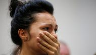 A woman reacts during a news briefing following the crash of the Boeing 737-800 plane, flight PS 752, on the outskirts of Tehran, at the Boryspil International Airport, outside Kiev, Ukraine January 8, 2020. REUTERS/Valentyn Ogirenko