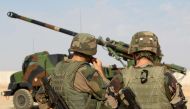French soldiers stand next to a CAESAR a French self-propelled 155 mm 52-calibre gun-howitzer in  this October 31 2016 file photo taken from a different location. (AFP) 