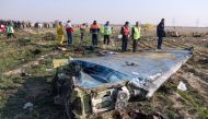 FILE PHOTO: Rescue teams are seen at the scene of a Ukrainian airliner that crashed shortly after take-off near Imam Khomeini airport in the Iranian capital Tehran. AFP/ Akbar TAVAKOLI