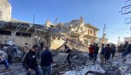 Syrians gather amidst the rubble following regime airstrikes on a market in the town of Binnish in Syria’s northwestern province of Idlib on January 11, 2020. (AFP / Omar HAJ KADOUR)
