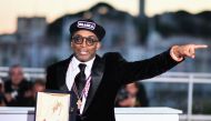 (FILES) In this file photograph taken on May 19, 2018, US director Spike Lee poses with his trophy during a photocall after he won the Grand Prix for the film 