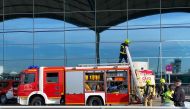 Firefighters work at Alicante-Elche airport on January 15, 2020 in Alicante after a fire erupted in the terminal. AFP / Daniel Leal-Olivas 