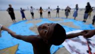 A child and climate change activists attend the Extinction Rebellion protests on Copacabana beach in Rio de Janeiro, Brazil, October 7, 2019. Reuters / Sergio Moraes