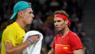 Rafael Nadal of Spain (R) walks to his end during his men's singles match against Alex de Minaur of Australia (L) at the ATP Cup tennis tournament in Sydney on January 11, 2020. (AFP / William WEST )