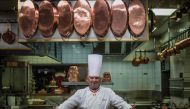 In this file photo taken on November 9, 2012 French chef Paul Bocuse, at Collonges au Mont d'Or, works in l'Aubergede Pont de Collonges kitchen, during a culinary work shop, in Mont d'Or. / AFP / JEFF PACHOUD
 