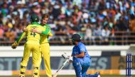 Australia's Adam Zampa (C) celebrates with teammate Alex Carey after dismissing India's Rohit Sharma during the second one day international (ODI) cricket match of a three-match series between India and Australia at Saurashtra Cricket Association Stadium 