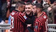 AC Milan's Croatian forward Ante Rebic (C) celebrates with AC Milan's Bosnian midfielder Rade Krunic (L) and AC Milan's French defender Theo Hernandez after scoring a last second winnin goal during the Italian Serie A football match AC Milan vs Udinese on