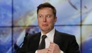 SpaceX founder and chief engineer Elon Musk retrieves his mobile phone during a post-launch news conference to discuss the SpaceX Crew Dragon astronaut capsule in-flight abort test at the Kennedy Space Center in Cape Canaveral, Florida, U.S. January 19, 2
