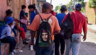 
Honduran migrants taking part in a caravan travelling to the US, line up to receive breakfast at a temporary shelter in Tecun Uman, Guatemala on January 19, 2020. AFP / Johan Ordonez 

 

 