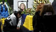 Relatives and colleagues attend a tribute ceremony and react in front of the flag-draped coffins of the 11 Ukrainians who died in a plane mistakenly shot down by Iran during a spike in tensions with Washington, which arrived in Boryapil airport, outside K