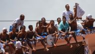 File photo: Inmates stand on the prison roof during a rebellion in Alcacuz Penitentiary Center near Natal, Rio Grande do Norte state, northeastern Brazil on January 16, 2017. AFP / Andressa Anholete