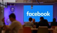 FILE PHOTO: Employees have lunch at the canteen at Facebook's new headquarters, designed by Canadian-born American architect Frank Gehry, at Rathbone Place in central London.  AFP / Daniel LEAL-OLIVAS