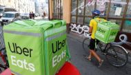An Uber Eats food delivery courier pulls a bicycle in central Kiev, Ukraine. (REUTERS/Valentyn Ogirenko/File Photo)
