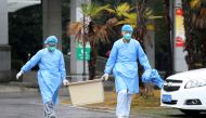 Medical staff carry a box as they walk at the Jinyintan hospital, where the patients with pneumonia caused by the new strain of coronavirus are being treated, in Wuhan, Hubei province, China January 10, 2020.  (REUTERS/Stringer/File Photo)