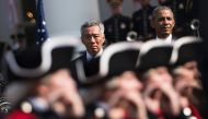 FILE PHOTO: Singapore Prime Minister Lee Hsien Loong and US President Barack Obama watch ceremonial troops during an arrival ceremony on the South Lawn of the White House, August 2, 2016, in Washington. AFP / Brendan Smialows
