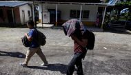 Honduran migrants walk after arriving on some buses with people of a caravan after being deported from Mexico, in Corinto, Honduras, January 22, 2020. REUTERS/Jorge Cabrera